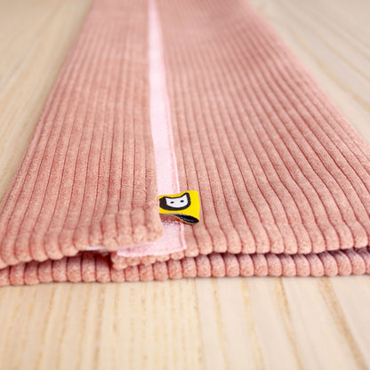 Funda pana rosa nueva sobre mesa de madera